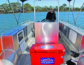 The side rails of the Ocean Craft can be set up with rod holders aft of the bimini. 